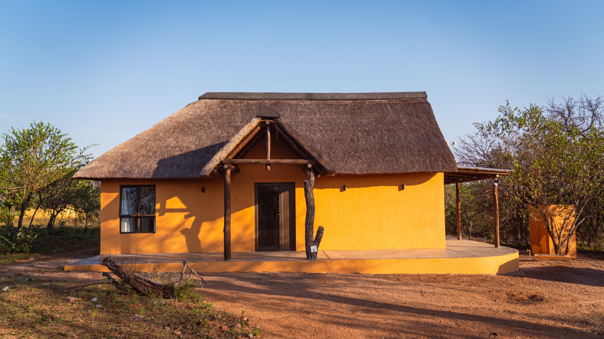 North Villa's ochre walls and thatch glowing at golden hour