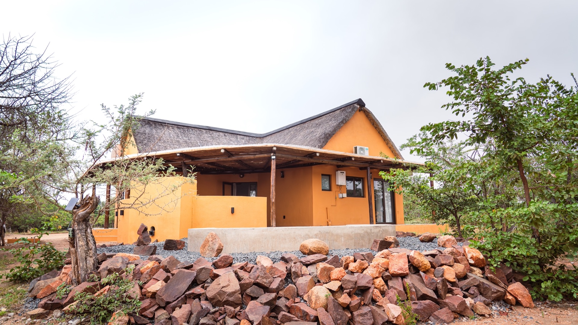 North Villa's ochre exterior and thatched roof in the bush